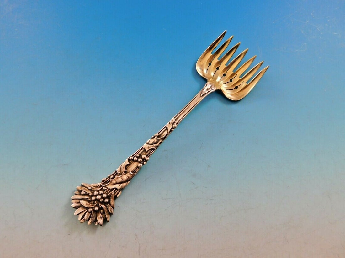 Tiffany & Co. Holly Sterling Silver 7-Tine Hors D'Oeuvre Fork 5 1/4": Tiffany & Co. Holly Sterling Silver 7-Tine Hors D'Oeuvre Fork 5 1/4" This exquisite hors d'oeuvre fork from Tiffany & Co. is crafted in sterling silver and features the iconic Holly pattern. Measuring