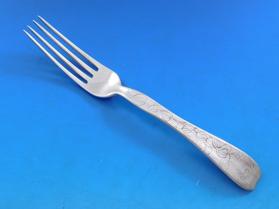 Tiffany & Co Sterling Silver Fork Lap Over Edge Butterfly 7 1/4": Tiffany & Co Sterling Silver Fork Lap Over Edge Butterfly 7 1/4" This exquisite sterling silver regular fork features a charming butterfly and flower motif, showcasing the elegant Lap Over Edge patter