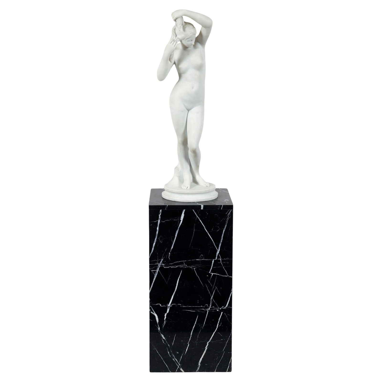Neoclassical Marble Nude Sculpture on Charcoal Pedestal 62 Inch Height: Neoclassical Marble Nude Sculpture on Charcoal Pedestal 62 Inch Height This neoclassical white marble statue features a classical standing nude beauty, possibly depicting Venus, in her bath. The statu