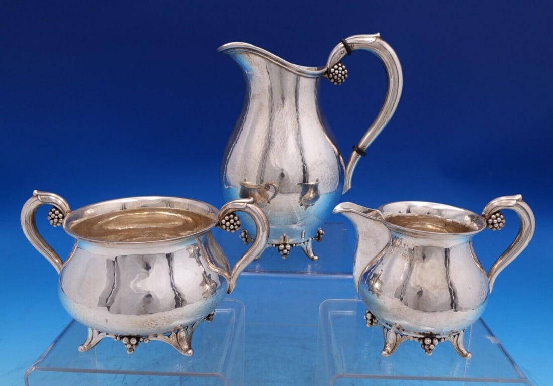 Grann & Laglye Grape Sterling Silver 3pc Creamer Sugar Set: Grann & Laglye Grape Sterling Silver 3pc Creamer Sugar Set Enhance your dining experience with this exquisite three-piece sugar and creamer set, featuring the elegant Grape pattern by Grann & Laglye.