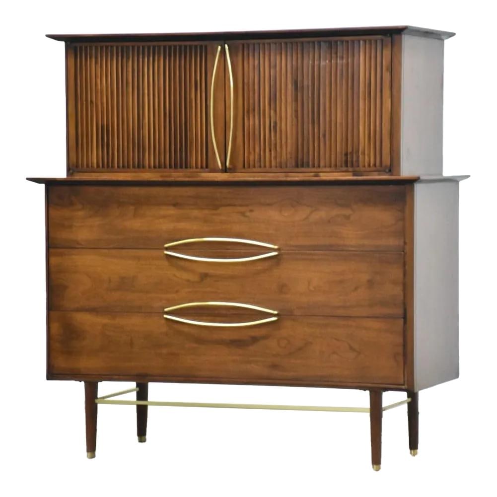Helen Hobey Mid Century Walnut Tall Dresser Brass Pulls 47.25": Helen Hobey Mid Century Walnut Tall Dresser Brass Pulls 47.25" This stunning mid-century modern tall dresser, designed by Helen Hobey for Baker, showcases a classic walnut finish complemented by polis