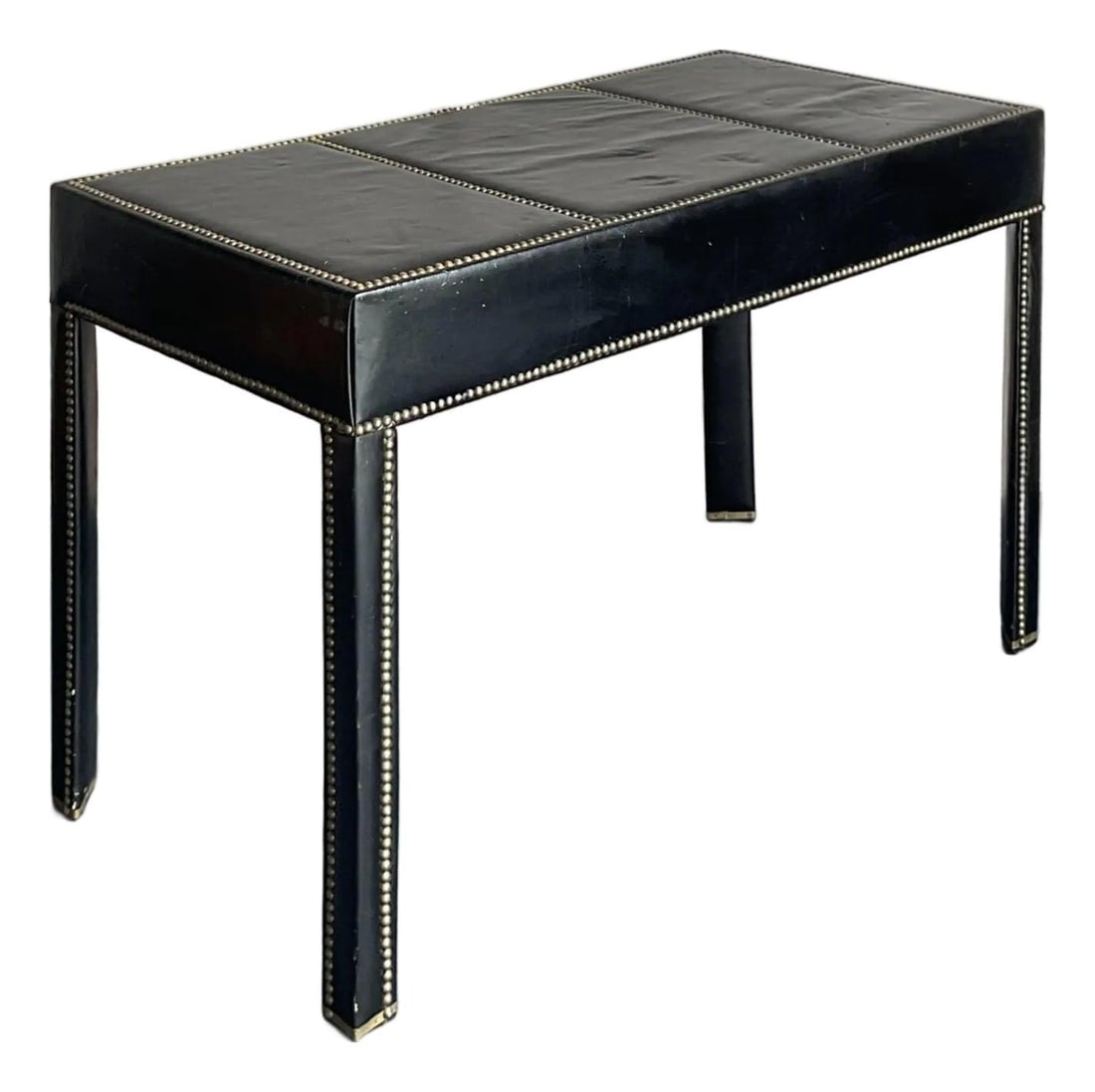 Black Leather Parsons Desk with Brass Nailhead Trim Hollywood Regency Style: Black Leather Parsons Desk with Brass Nailhead Trim Hollywood Regency Style This vintage desk exemplifies Hollywood Regency and Campaign-style design with a classic Parsons silhouette. Wrapped in supp