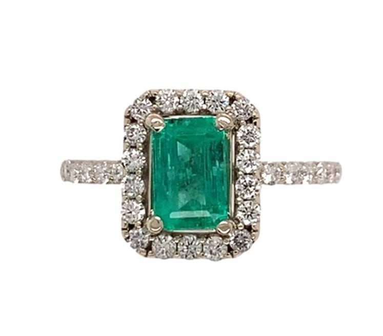 14k White Gold 1 Carat Emerald Diamond Halo Ring GIA Certified: 14k White Gold 1 Carat Emerald Diamond Halo Ring GIA Certified This exquisite ring features a stunning 1 carat genuine natural emerald at its center, elegantly surrounded by a halo of diamonds. The em