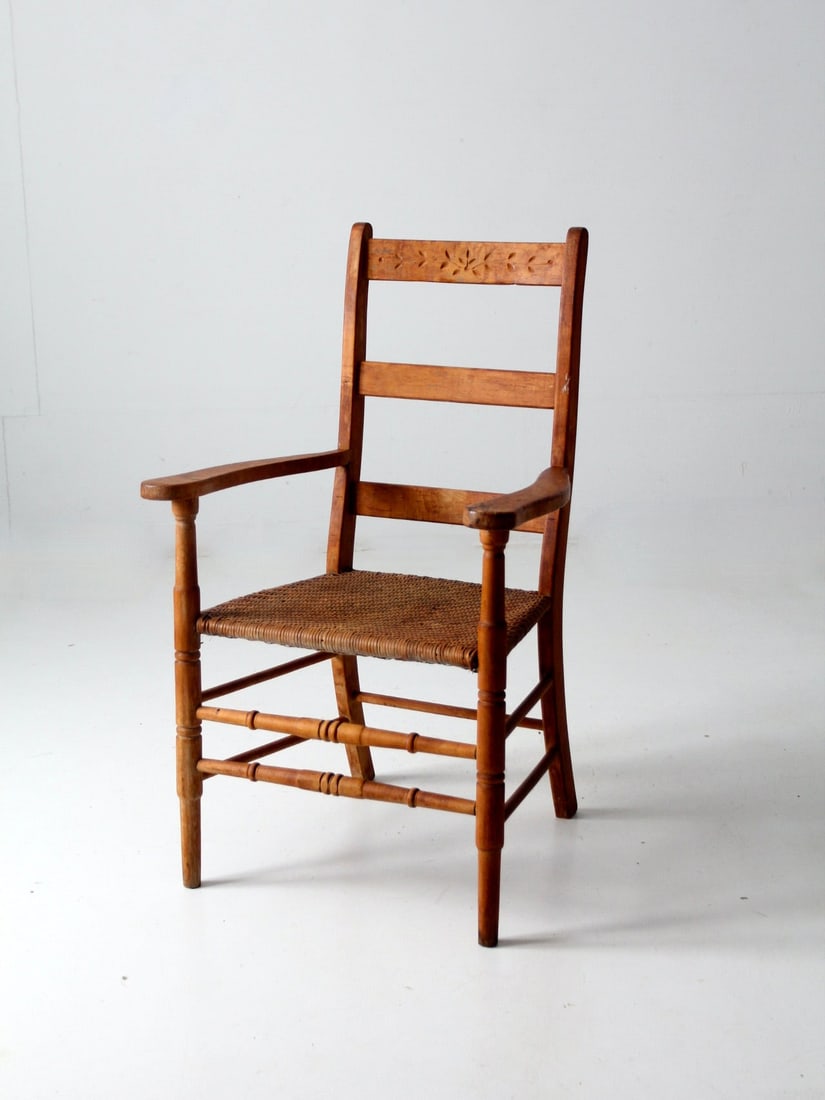 Antique Armchair with Herringbone Cane Seat and Floral Carving: Antique Armchair with Herringbone Cane Seat and Floral Carving Discover an elegant antique woven seat armchair, showcasing a stunning herringbone cane weave seat complemented by a beautifully carved f