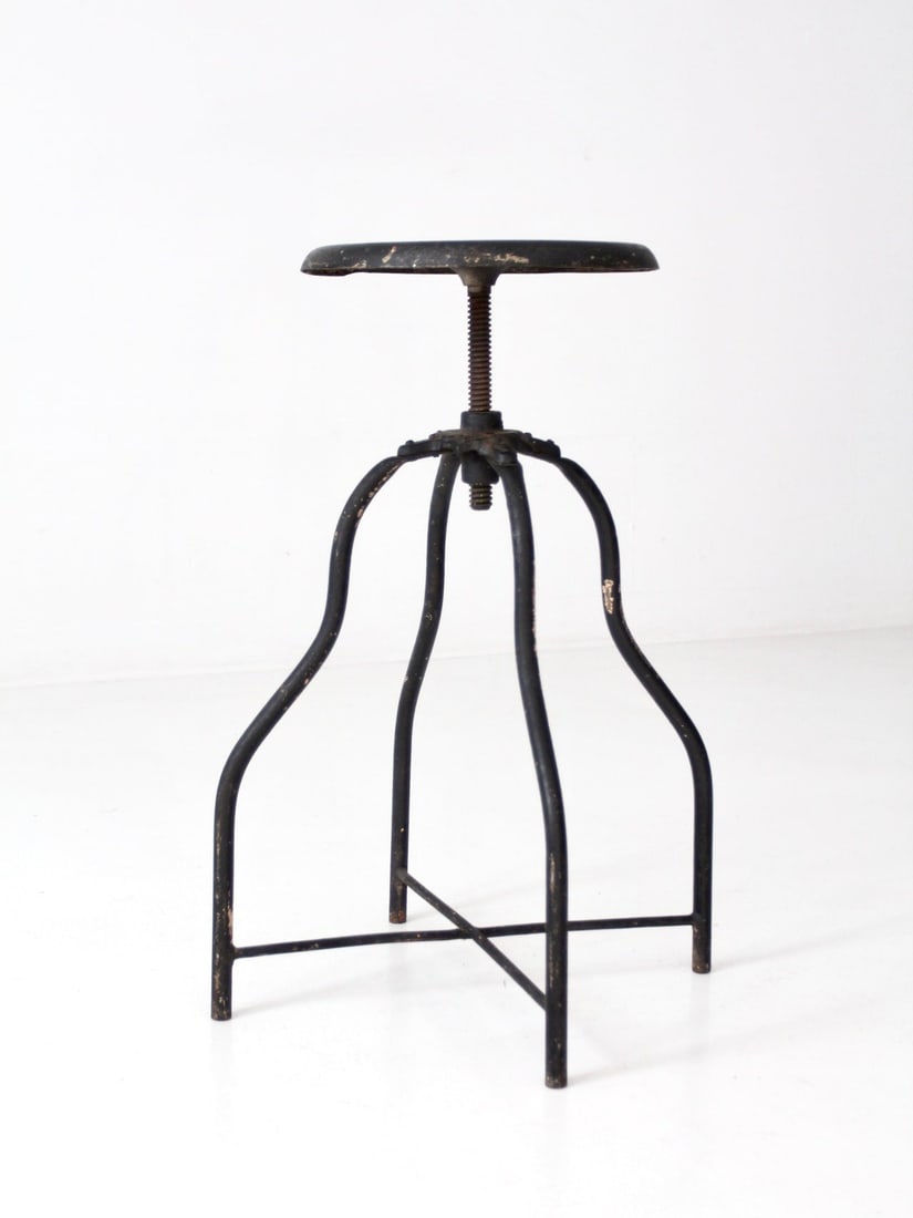 Vintage Adjustable Black Metal Industrial Stool 24.5 to 30 in: Vintage Adjustable Black Metal Industrial Stool 24.5 to 30 in This vintage industrial stool combines functionality with style. Crafted from black metal, it features an adjustable seat, allowing for ve