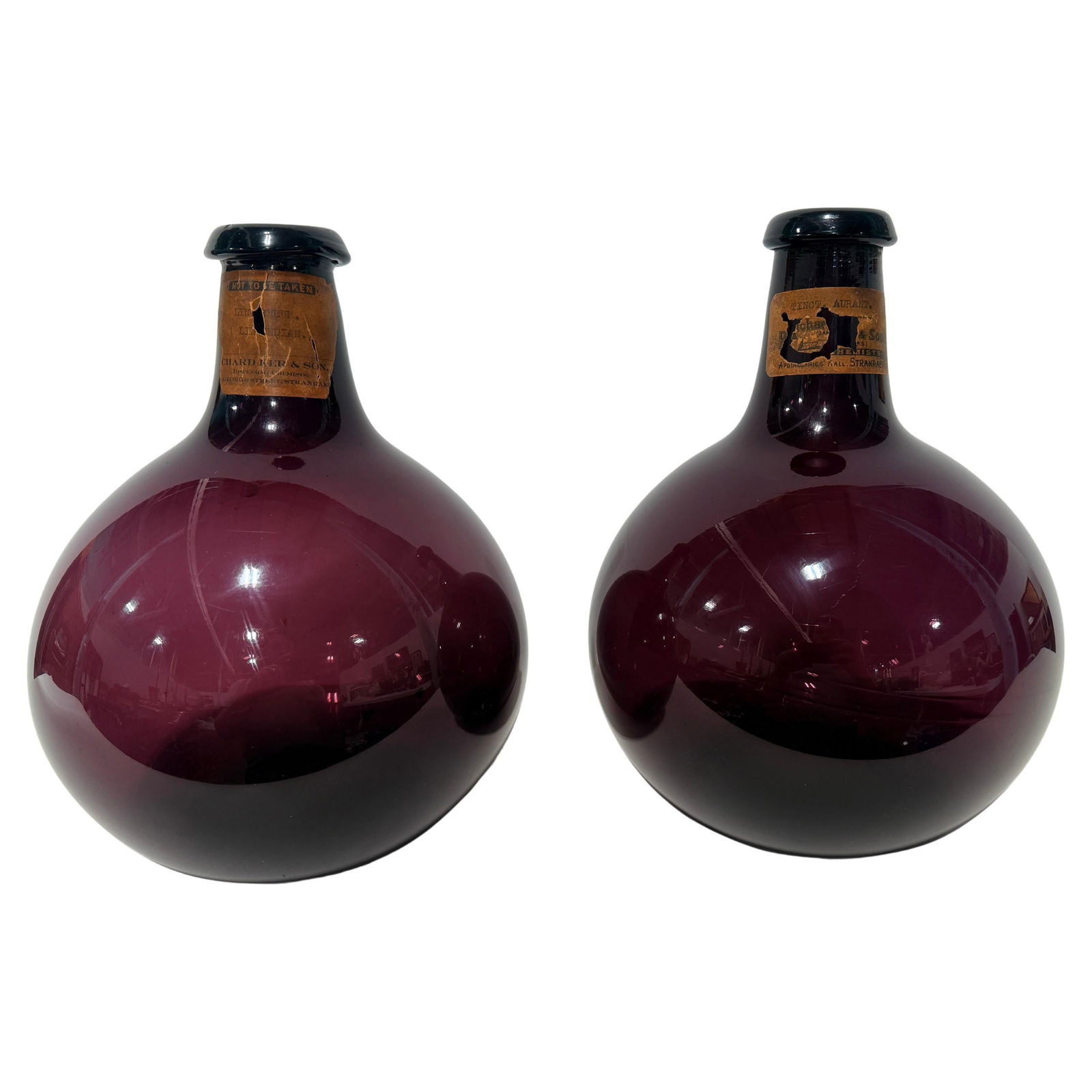 Set of 2 Scottish Amethyst Apothecary Bottles With Labels Circa 1890: Set of 2 Scottish Amethyst Apothecary Bottles With Labels Circa 1890 This is a matched pair of Scottish apothecary display bottles crafted from deeply saturated amethyst (blackberry) blown glass, dati