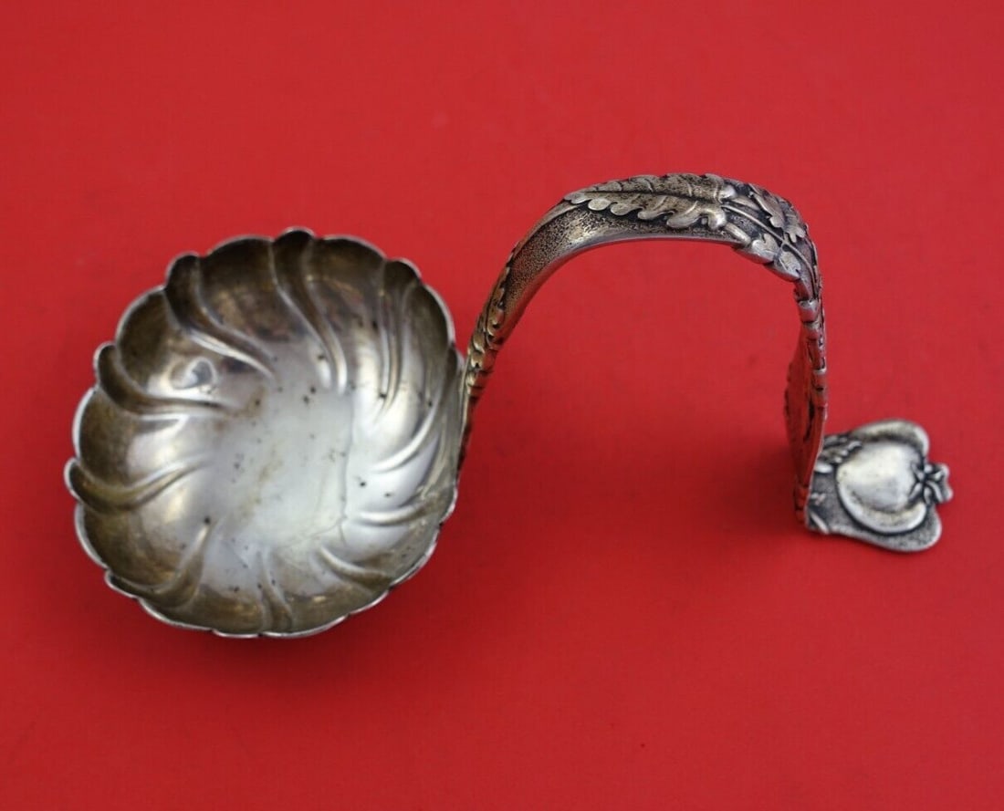 Tiffany & Co Vine Sterling Silver Soup Ladle Tomato Motif 8.5": Tiffany & Co Vine Sterling Silver Soup Ladle Tomato Motif 8.5" This exquisite soup ladle from the esteemed Vine pattern by Tiffany & Co. showcases a stunning bent handle and a delightful tomato motif,