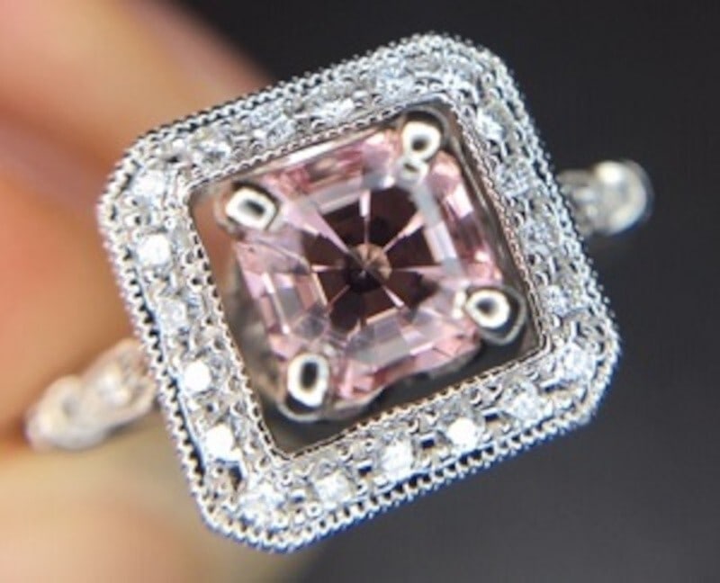 14k White Gold Asscher Morganite Diamond Halo Ring GIA Certified: 14k White Gold Asscher Morganite Diamond Halo Ring GIA Certified This stunning 14k white gold ring showcases a specialty Asscher cut genuine natural morganite, weighing 0.61cts and measuring 5mm squar