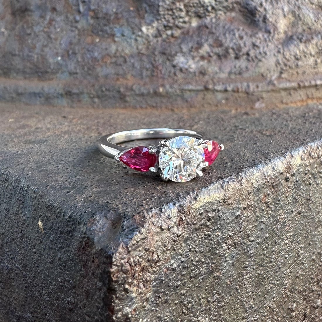 Platinum Engagement Ring with GIA Certified Diamond and Pear Shaped Ruby Accents: Platinum Engagement Ring with GIA Certified Diamond and Pear Shaped Ruby Accents This platinum engagement ring features a natural, GIA-certified round brilliant cut diamond at its center, graded I col