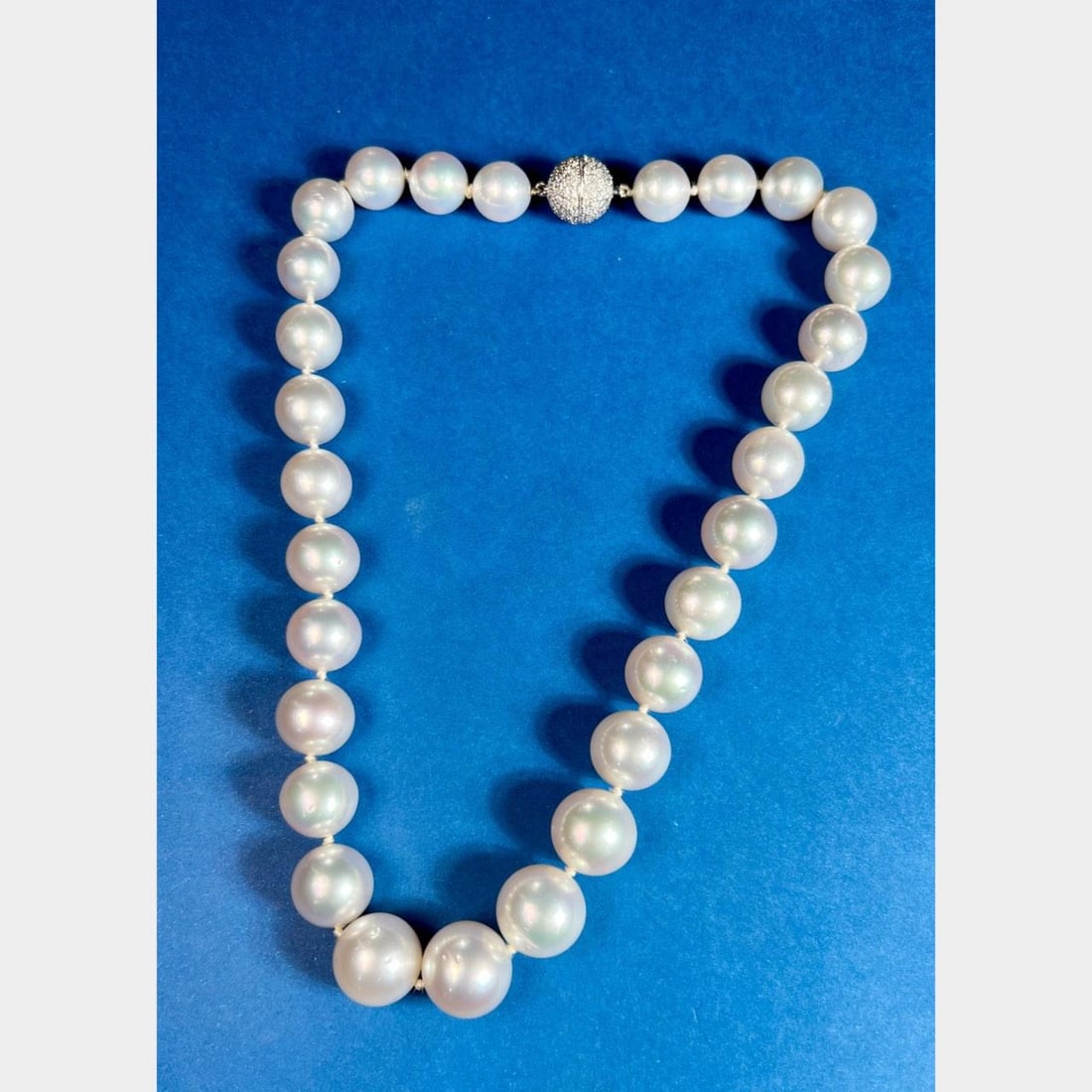 Elegant 17 Inch Graduated South Sea Pearl Necklace 18K White Gold Diamond Clasp: Elegant 17 Inch Graduated South Sea Pearl Necklace 18K White Gold Diamond Clasp This exquisite graduated South Sea pearl necklace features lustrous pearls ranging in size from 15.6mm to 11.6mm, gracef