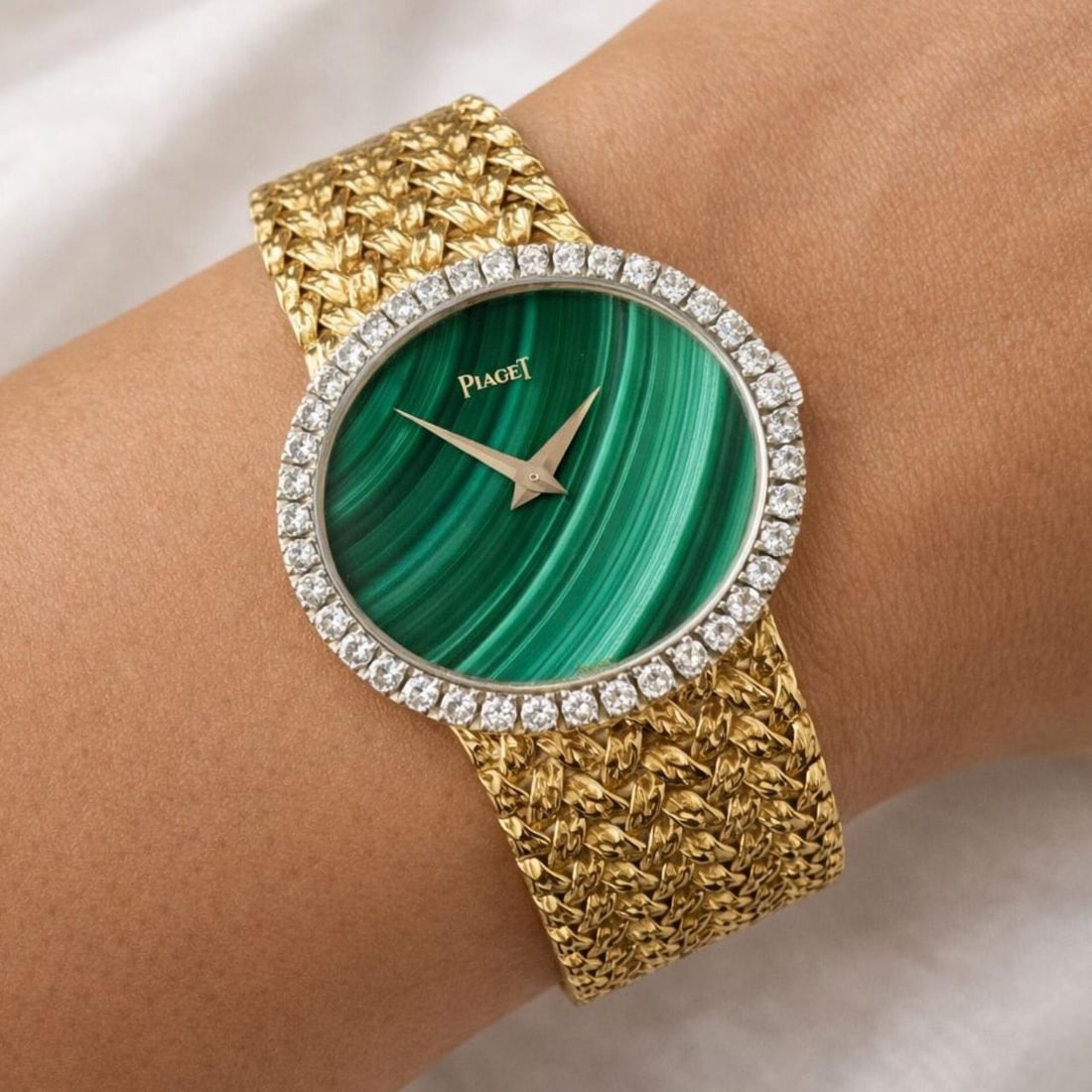 Piaget Malachite Dial Ladies Watch 18K Yellow Gold Diamond Bezel 27 x 24mm Quartz: Piaget Malachite Dial Ladies Watch 18K Yellow Gold Diamond Bezel 27 x 24mm Quartz Elegant ladies watch crafted from 18K yellow gold, featuring a factory original malachite dial and diamond-set bezel.
