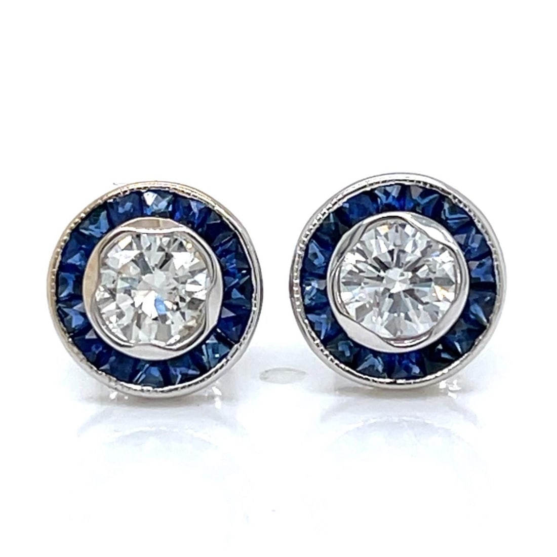 Diamond and Sapphire Stud Earrings in 18K White Gold 2.4g: Diamond and Sapphire Stud Earrings in 18K White Gold 2.4g These stud earrings are crafted in 18K white gold and feature two diamonds with a combined weight of 0.79 carats, displaying F-G color and SI1