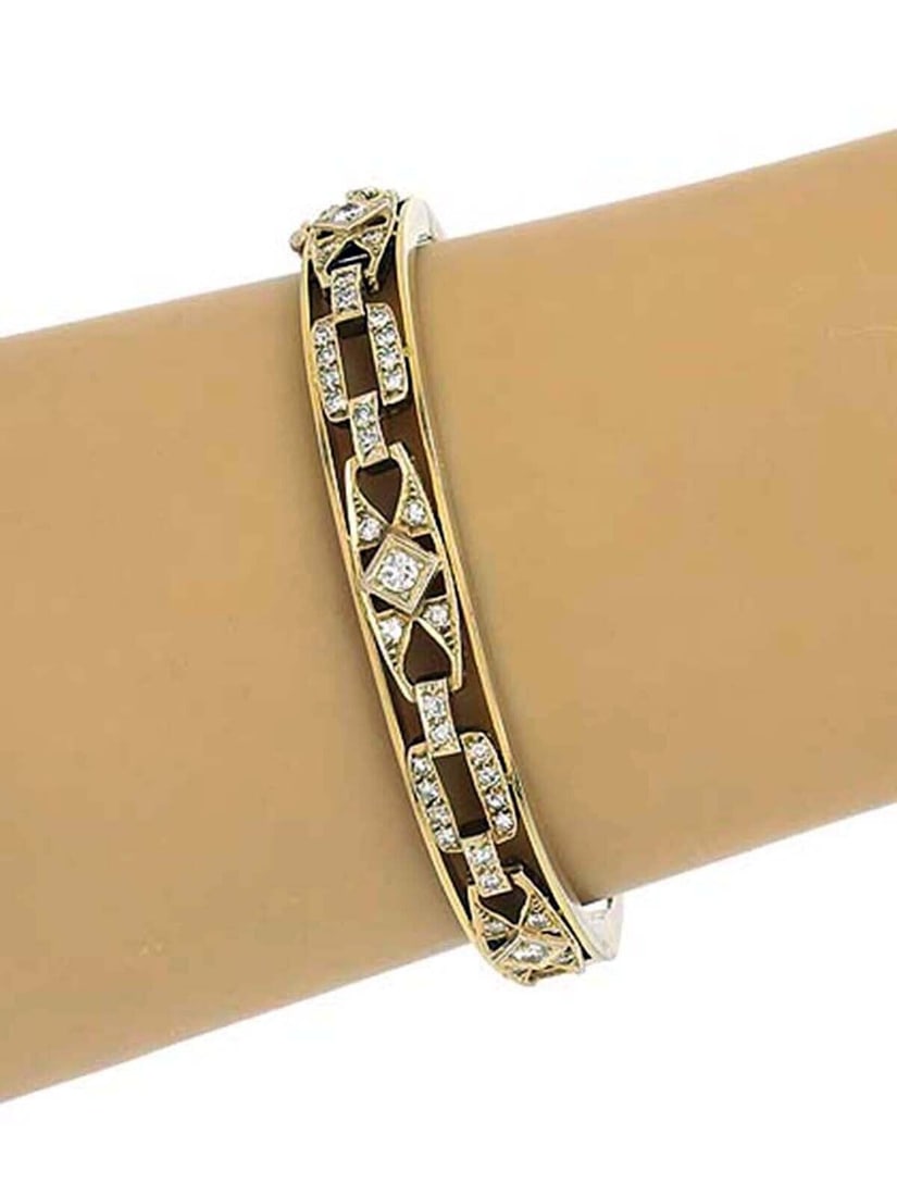 Estate 14k Yellow Gold Bangle Bracelet with Openwork and 0.75ct Diamonds: Estate 14k Yellow Gold Bangle Bracelet with Openwork and 0.75ct Diamonds This vintage bangle bracelet is crafted from 14k yellow gold and features an openwork design that encircles the entire band. Th