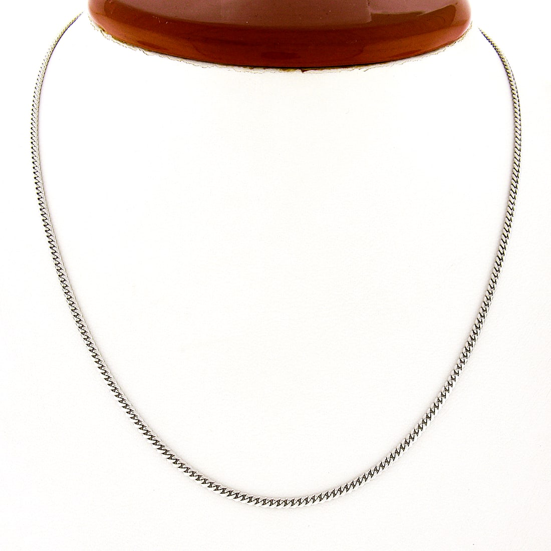 14k White Gold 2mm 16 Inch Unisex Cuban Curb Link Necklace: 14k White Gold 2mm 16 Inch Unisex Cuban Curb Link Necklace This exquisite necklace features a unisex design crafted from solid 14k white gold, showcasing a polished Cuban curb link style. The chain