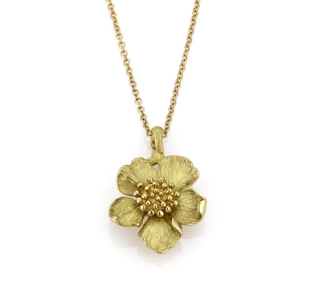 Dogwood Floral Pendant Necklace in 18k Yellow Gold by Tiffany & Co.: Dogwood Floral Pendant Necklace in 18k Yellow Gold by Tiffany & Co. This Tiffany & Co. Dogwood pendant necklace features an elegant floral design crafted in 18k yellow gold. The necklace is signed and