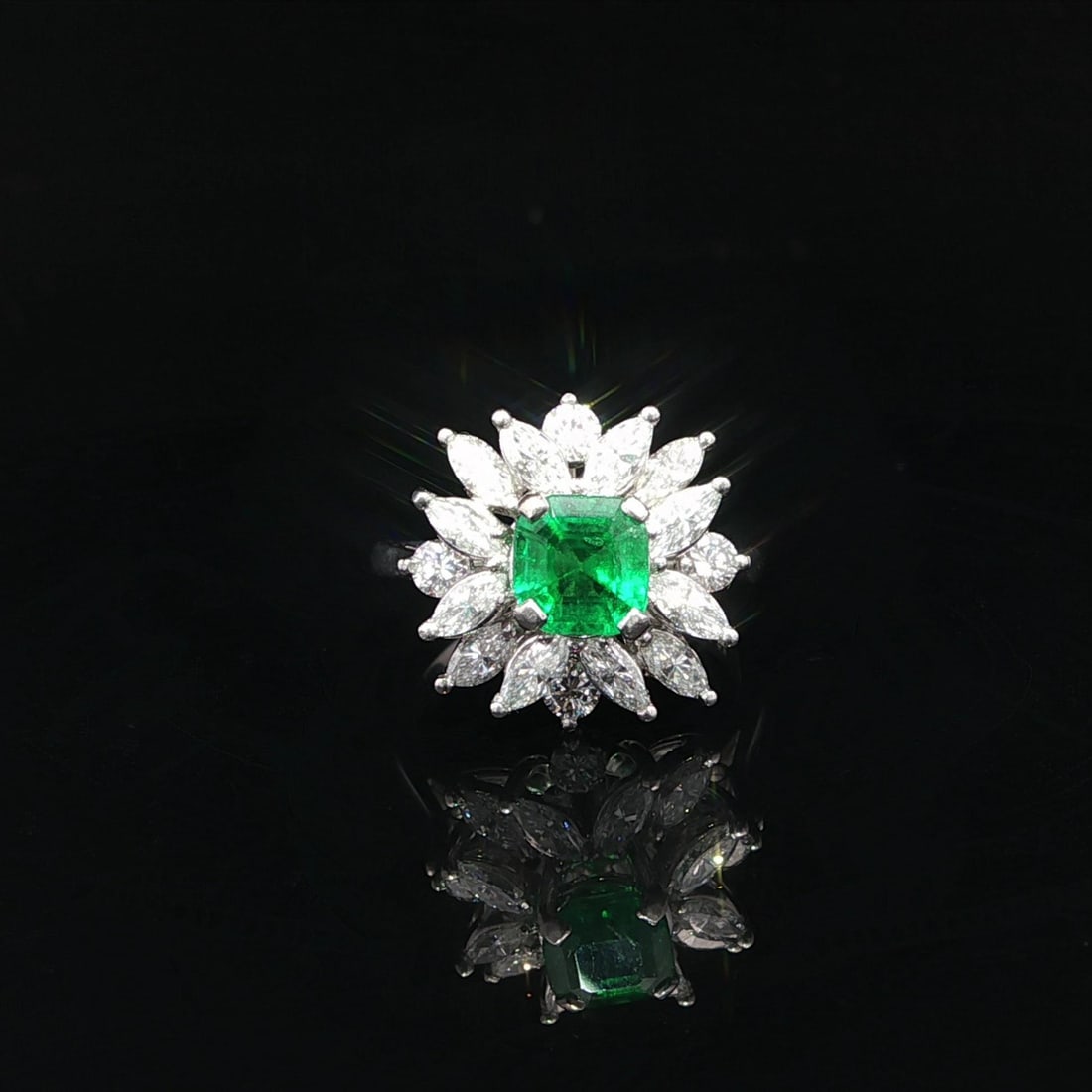 Vintage Platinum 2.40ctw Emerald Marquise Diamond Cocktail Ring: Vintage Platinum 2.40ctw Emerald Marquise Diamond Cocktail Ring This exquisite vintage cocktail ring showcases a stunning natural emerald at its center, measuring approximately 5.5x5.7 mm and weighing