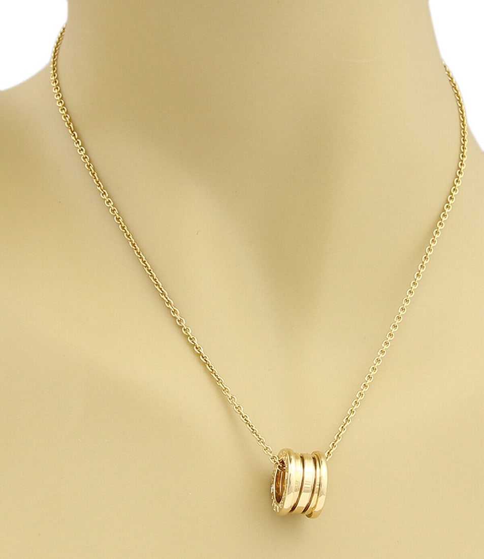 18k Yellow Gold B.zero1 Pendant Necklace by Bvlgari: 18k Yellow Gold B.zero1 Pendant Necklace by Bvlgari The Bvlgari B.zero1 Pendant Necklace is crafted in 18k yellow gold and features the iconic Bvlgari branding. This original designer piece includes a