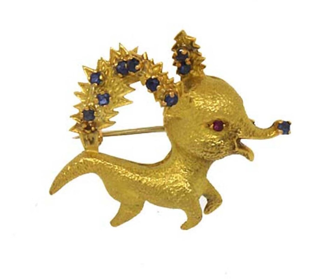Vintage French Reindeer Brooch in 18k Yellow Gold with Sapphire and Ruby: Vintage French Reindeer Brooch in 18k Yellow Gold with Sapphire and Ruby This vintage brooch features an intricate baby reindeer design adorned with sparkling sapphire and ruby stones. Expertly crafte