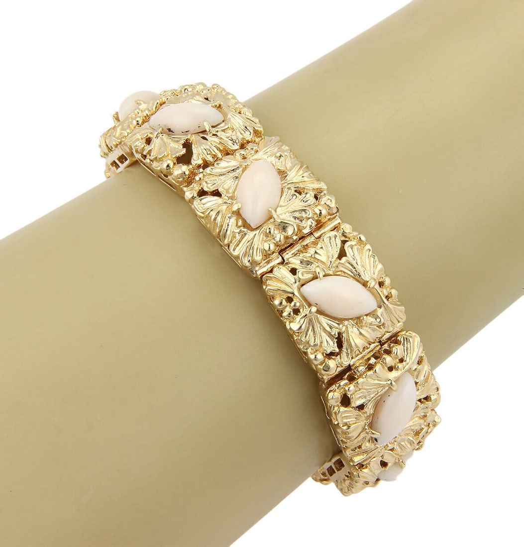Square Link 14k Gold Bracelet with Angel Skin Coral Floral Design: Square Link 14k Gold Bracelet with Angel Skin Coral Floral Design This vintage bracelet features an intricate floral design crafted from angel skin coral, set in solid 14k yellow gold. The square link