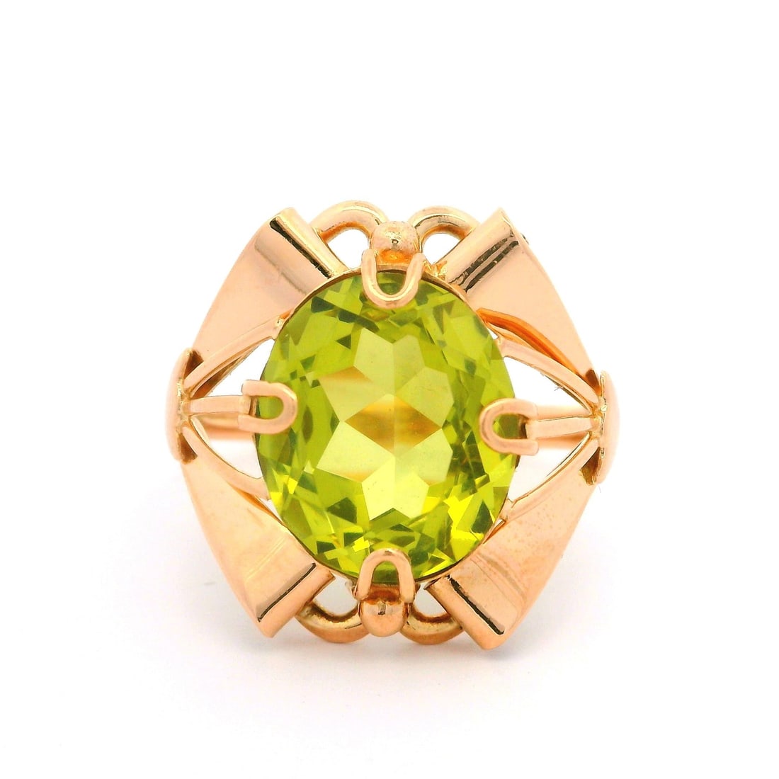 Vintage 14k Rosy Yellow Gold Green Gemstone Ribbon Cocktail Ring: Vintage 14k Rosy Yellow Gold Green Gemstone Ribbon Cocktail Ring This Vintage Retro cocktail ring features a stunning oval brilliant cut lime green gemstone, prong set, and measuring approximately 12.