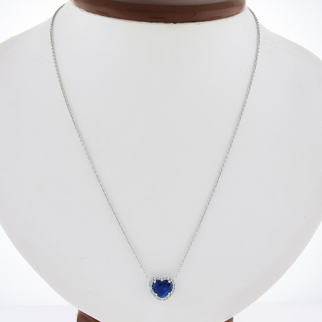 Platinum 2.27ct Heart Blue Sapphire Diamond Halo Pendant Necklace: Platinum 2.27ct Heart Blue Sapphire Diamond Halo Pendant Necklace This elegant pendant necklace features a stunning heart-shaped royal blue sapphire, weighing 2.06ct, surrounded by a halo of 20 sparkl