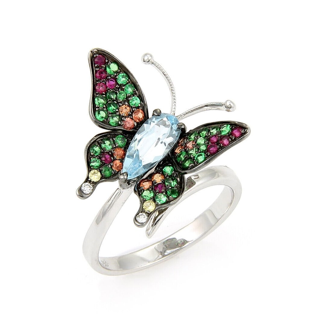 18k White Gold Butterfly Ring with Blue Topaz Tsavorite Sapphire Stones Size 7: 18k White Gold Butterfly Ring with Blue Topaz Tsavorite Sapphire Stones Size 7 This butterfly-shaped ring features vibrant blue topaz, tsavorite garnet, and sapphire gemstones set in 18k white gold. T