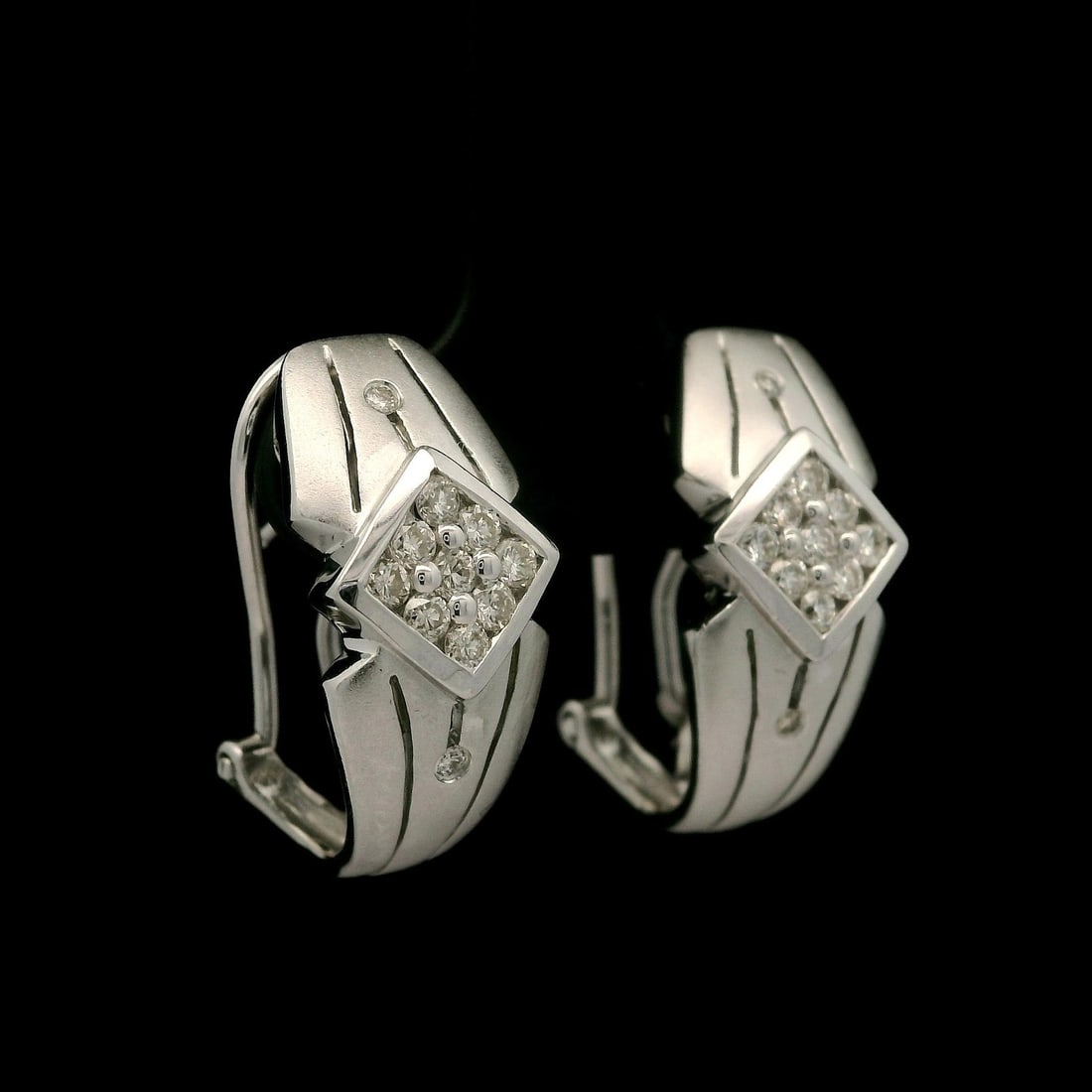 14k White Gold 0.30ctw Diamond Geometric Cuff Earrings: 14k White Gold 0.30ctw Diamond Geometric Cuff Earrings These elegant cuff earrings are crafted from solid 14k white gold and feature a stunning geometric lozenge design. The earrings are adorned with