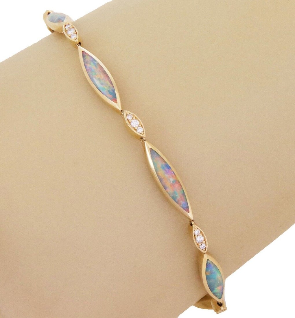 18k Yellow Gold Bracelet with Fire Opal and Diamond Marquise Links by Kabana: 18k Yellow Gold Bracelet with Fire Opal and Diamond Marquise Links by Kabana This authentic Kabana bracelet is crafted from 18k yellow gold and features a marquise link design. It is set with fire opa