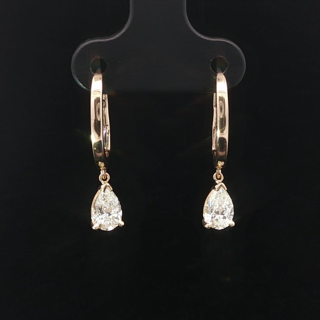 GIA Certified Pear Diamond Drop Earrings in 14k Yellow Gold 0.94ctw: GIA Certified Pear Diamond Drop Earrings in 14k Yellow Gold 0.94ctw These un-used dangle drop hoop earrings are crafted from solid 14k yellow gold and feature two natural pear-shaped diamonds with a c