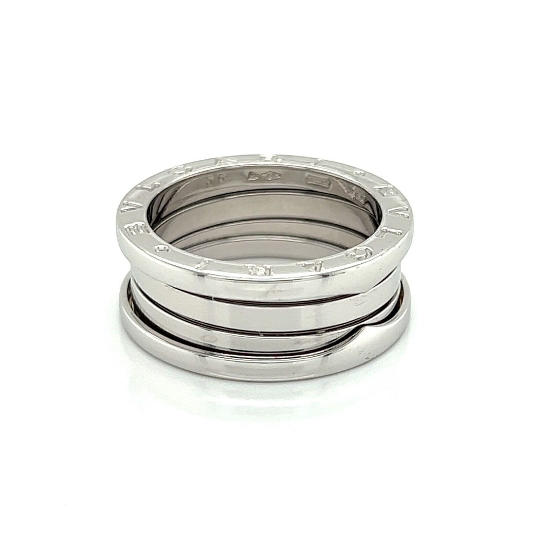 B.zero1 Three-Band 18k White Gold Ring Size 7.5 with Certificate: B.zero1 Three-Band 18k White Gold Ring Size 7.5 with Certificate This authentic Bvlgari B.zero1 Three Band Ring is crafted in 18k white gold and features a sleek, high-polished finish. Showcasing the