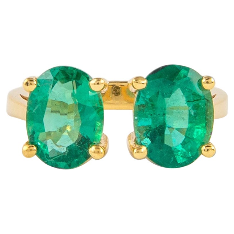 Toi Et Moi 3.78ct Emerald Ring in 18k Yellow Gold: Toi Et Moi 3.78ct Emerald Ring in 18k Yellow Gold This exquisite 3.78 carat Toi Et Moi emerald ring features two stunning oval-cut emeralds set in luxurious 18k yellow gold. The modern design showcase