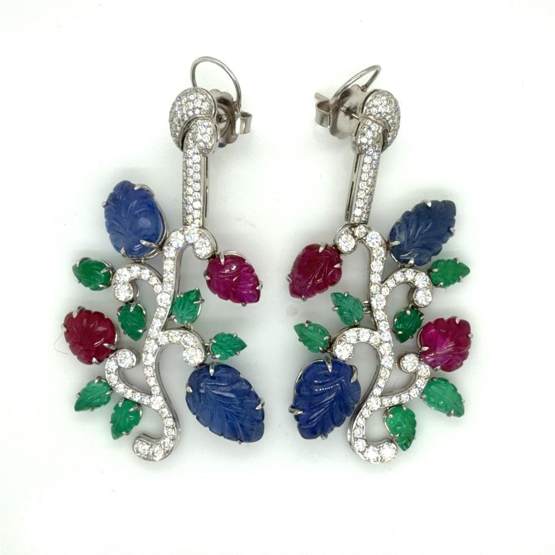 34.7g Platinum Earrings With Diamonds Emeralds Sapphires And Rubies 2.5 Inch: 34.7g Platinum Earrings With Diamonds Emeralds Sapphires And Rubies 2.5 Inch These pre-owned earrings are crafted in platinum and feature an impressive array of gemstones. Each earring is set with car