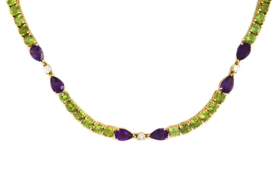 18k Yellow Gold Fancy Necklace with 57ct Peridot & Amethyst: 18k Yellow Gold Fancy Necklace with 57ct Peridot & Amethyst This exquisite estate necklace showcases a stunning design crafted from 18k yellow gold. The necklace features elongated sections, each conn