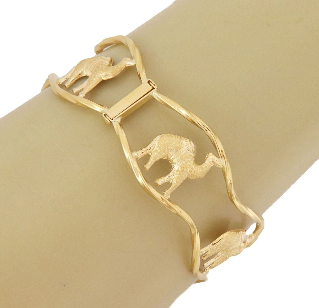 18k Yellow Gold Wide Wave Openwork Cuff Bangle Bracelet with Camel Motif: 18k Yellow Gold Wide Wave Openwork Cuff Bangle Bracelet with Camel Motif This statement cuff bangle bracelet is expertly crafted from solid 18k yellow gold and features a wide, open wave design with a