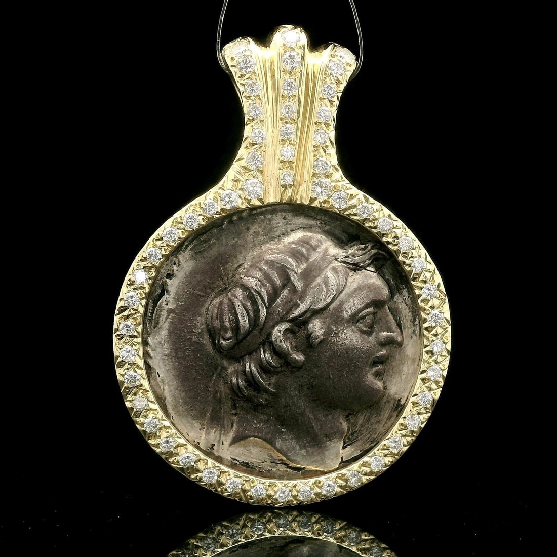 14k Yellow Gold Silver Ancient Coin Pendant with 0.60ct Diamond Frame: 14k Yellow Gold Silver Ancient Coin Pendant with 0.60ct Diamond Frame This stunning pendant features a solid silver ancient coin elegantly framed in 14k yellow gold, adorned with 55 natural diamonds t