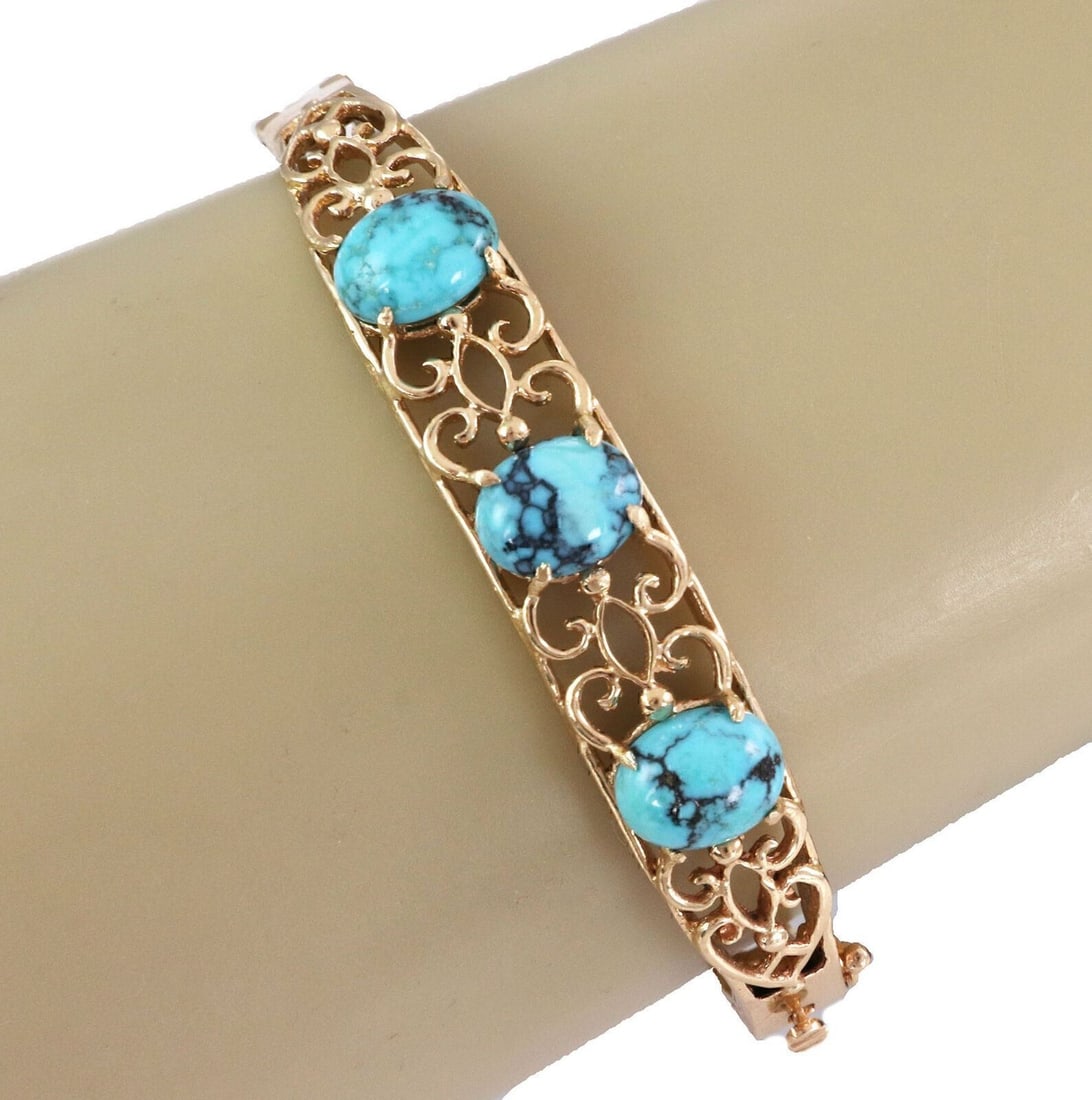 Hinged Bangle Bracelet with Turquoise Stone in 14k Yellow Gold Scroll Design: Hinged Bangle Bracelet with Turquoise Stone in 14k Yellow Gold Scroll Design This vintage bangle bracelet features an intricate fancy scroll design crafted in 14k yellow gold. At its center, the brace