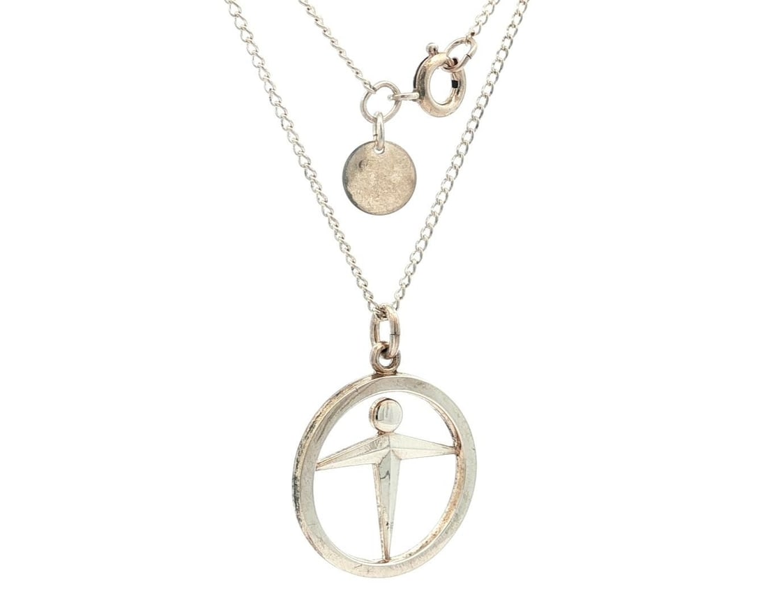 Tiffany & Co. Sterling Silver Manpower Unity Pendant Necklace: Tiffany & Co. Sterling Silver Manpower Unity Pendant Necklace This elegant Sterling Silver Tiffany & Co. Manpower Unity Pendant is gracefully suspended on a fine cable link chain. Crafted from high-qu