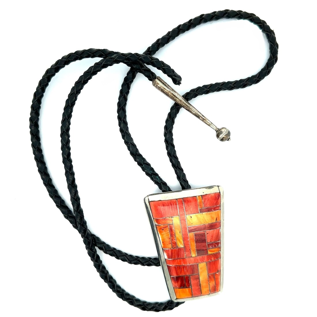 Sterling Silver Tapered Bolo Tie with Orange Stone Inlay on Black Leather: Sterling Silver Tapered Bolo Tie with Orange Stone Inlay on Black Leather This bolo tie features a sterling silver slide with custom inlay of numerous natural, genuine stones in light to medium orange