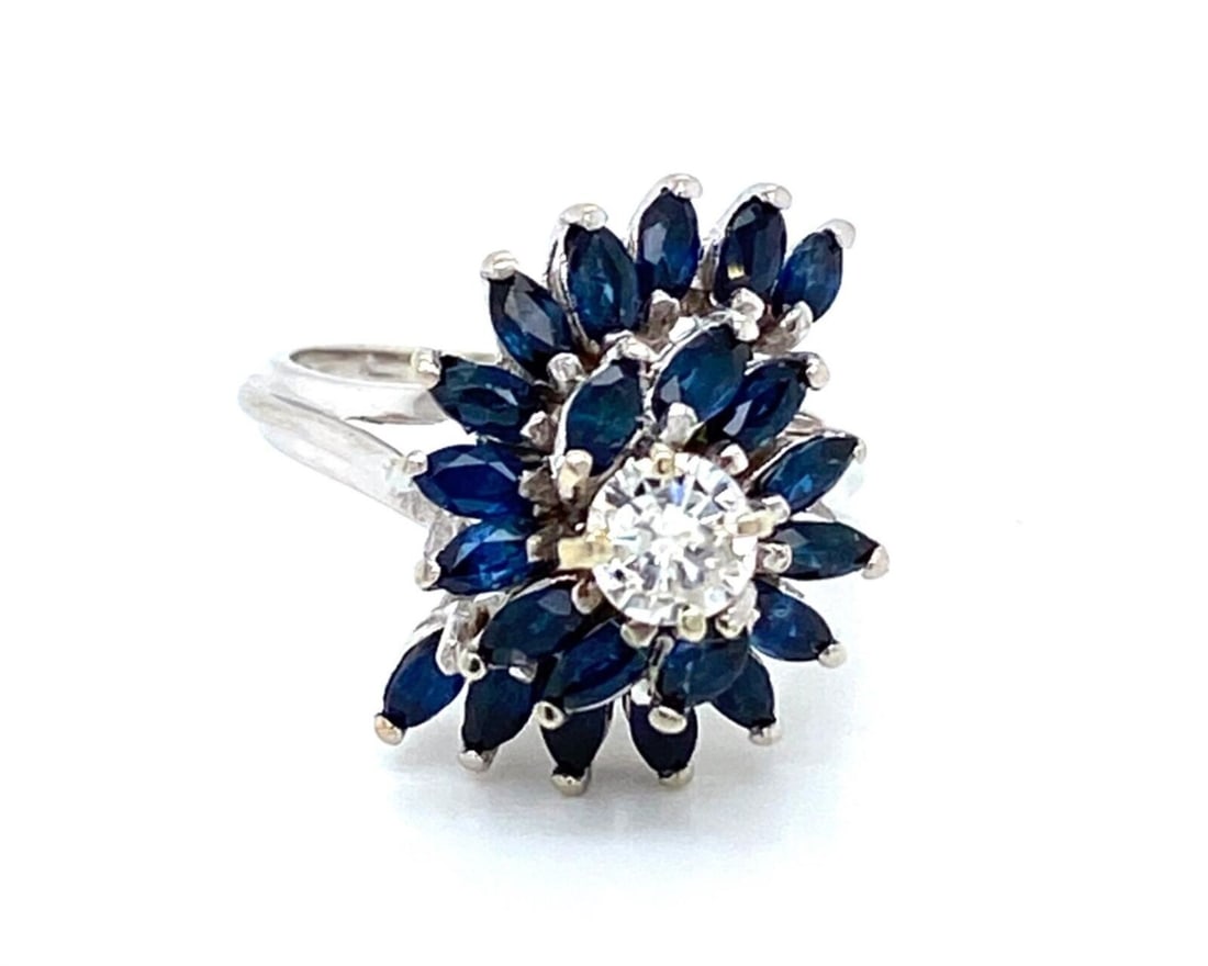 Swirl Motif 14k White Gold Ring with Diamonds and Sapphires Size 6.5: Swirl Motif 14k White Gold Ring with Diamonds and Sapphires Size 6.5 This elegant ring features a swirl design set with diamonds and sapphires, expertly crafted in 14k white gold. The piece is hallmar