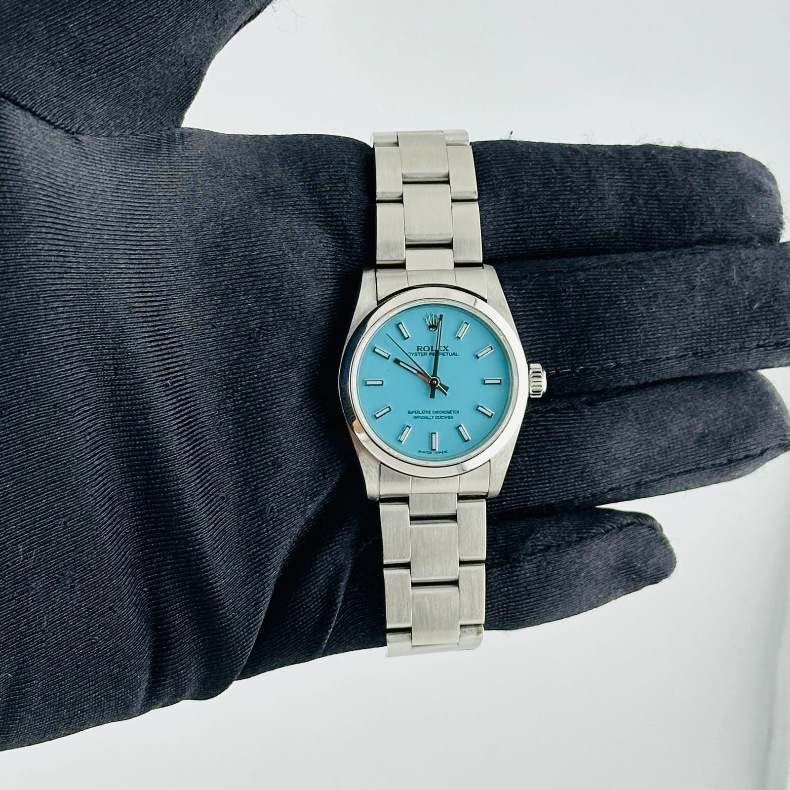 Ladies Rolex 77080 Oyster Perpetual with Aftermarket Tiffany Dial and Oyster Bracelet: Ladies Rolex 77080 Oyster Perpetual with Aftermarket Tiffany Dial and Oyster Bracelet This Rolex Oyster Perpetual watch features an aftermarket Tiffany dial, a smooth bezel, and an Oyster bracelet. De