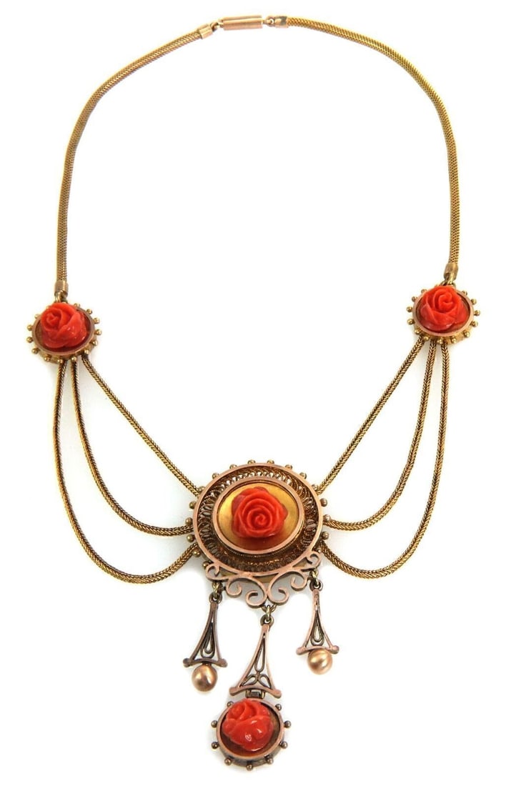 Vintage Bib Necklace with Carved Rose Coral and 14k Yellow Gold: Vintage Bib Necklace with Carved Rose Coral and 14k Yellow Gold This vintage bib necklace features intricately carved rose coral set in 14k yellow gold. The unique bib-style design highlights the deta