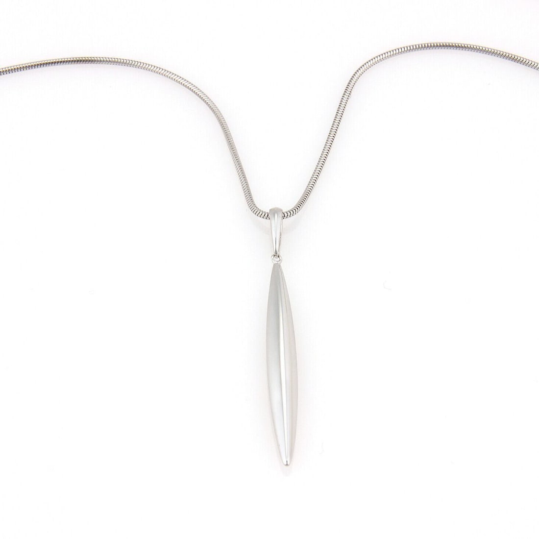 18k White Gold Feather Pendant Necklace with Snake Chain by Tiffany & Co.: 18k White Gold Feather Pendant Necklace with Snake Chain by Tiffany & Co. This elegant necklace features a delicate feather pendant crafted from 18k white gold, paired with a sleek snake chain. The re