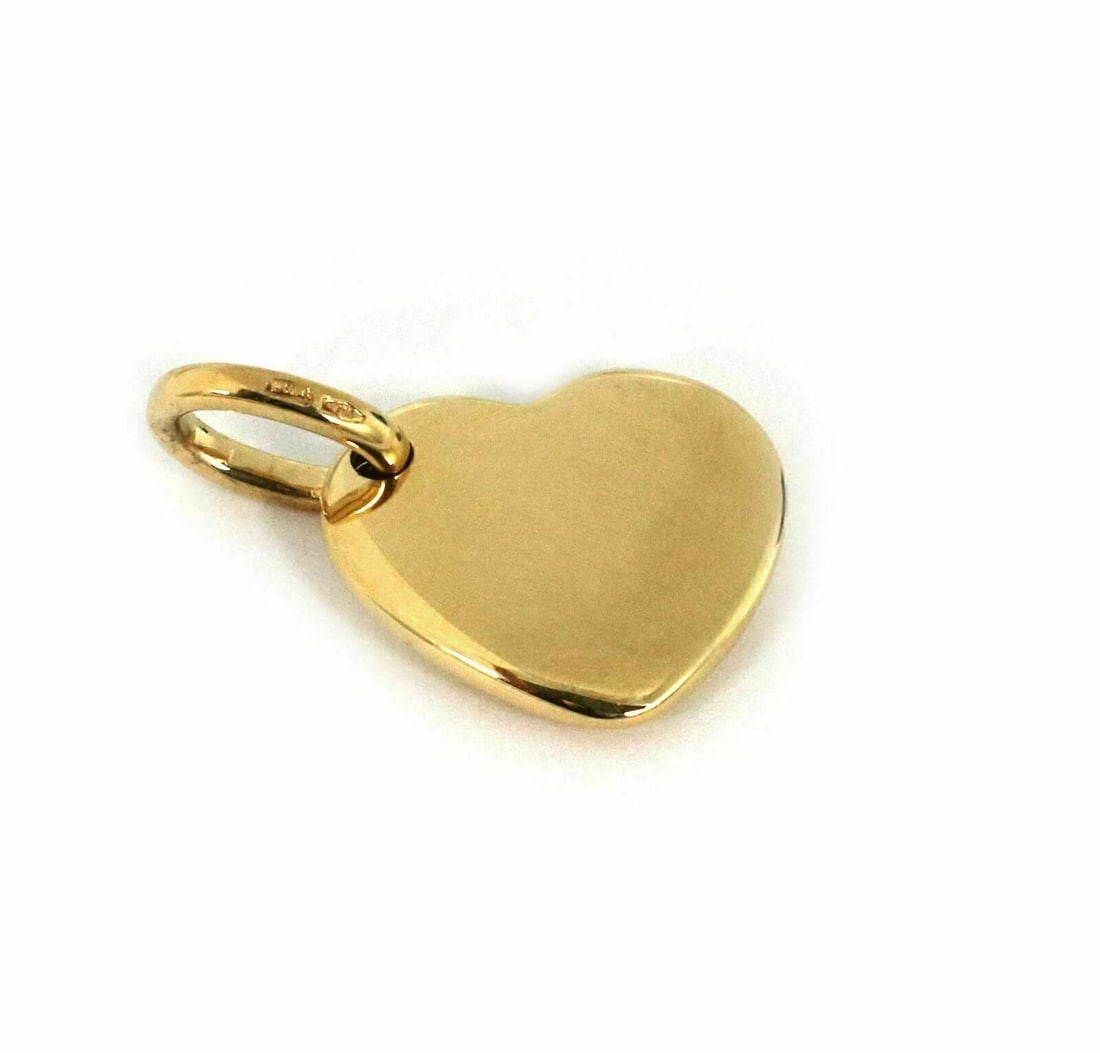 18k Yellow Gold Heart Pendant Charm by Pomellato: 18k Yellow Gold Heart Pendant Charm by Pomellato This Pomellato puffed heart charm pendant is crafted from 18k yellow gold and features a signature from the Pomellato brand. The pendant's elegant puff