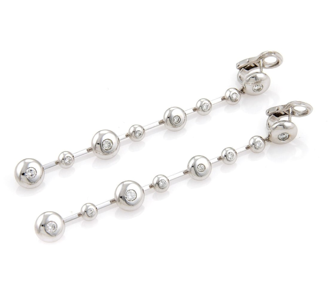 Dangle Earrings With Spinner Discs In 18k White Gold And Diamonds By Koesia: Dangle Earrings With Spinner Discs In 18k White Gold And Diamonds By Koesia These Koesia earrings feature a dangle/drop style with a distinctive spinner discs design. Crafted from 18k white gold and s