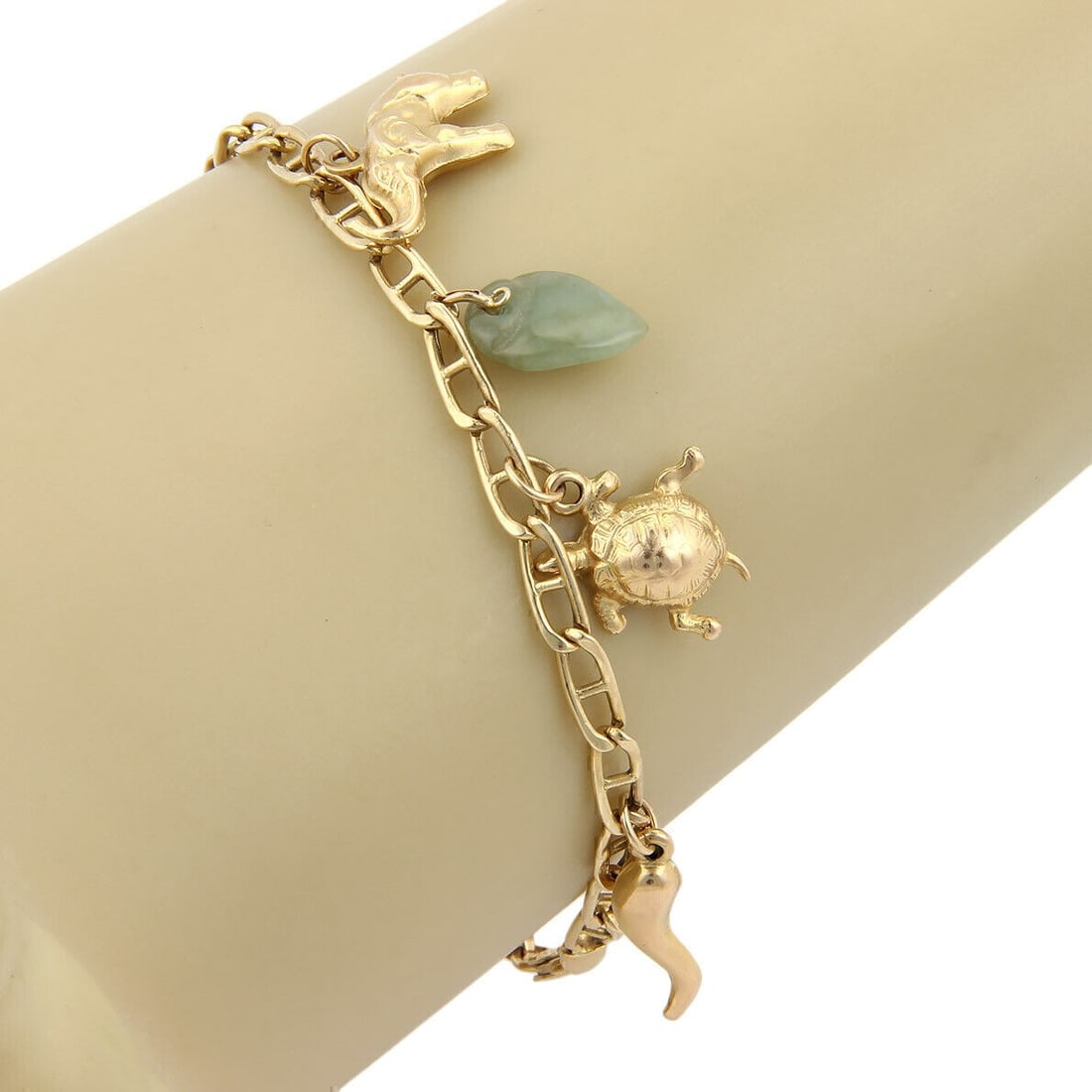 Vintage 14k Yellow Gold Jadeite Bracelet With Seven Unique Charms: Vintage 14k Yellow Gold Jadeite Bracelet With Seven Unique Charms This vintage charm link bracelet features seven assorted jadeite charms set in 14k yellow gold. The bracelet measures 7.5 inches in le