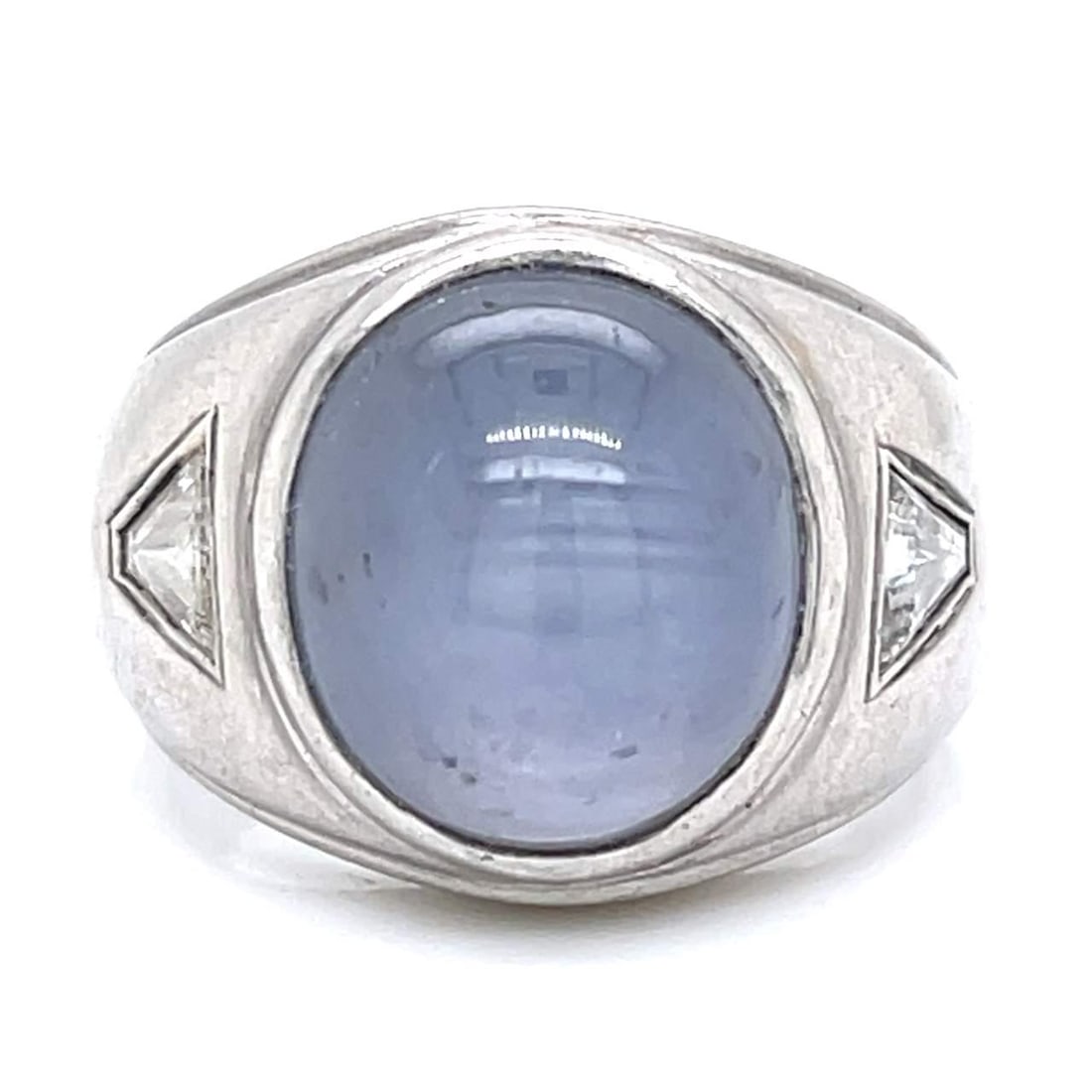 Platinum 21.00 Ct Star Sapphire Ring with 2 Trilliant Diamonds: Platinum 21.00 Ct Star Sapphire Ring with 2 Trilliant Diamonds This exquisite Platinum ring features a stunning 21.00 Ct. Star Sapphire at its center, complemented by two Trilliant Diamonds totaling a