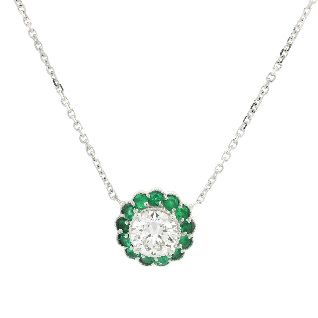 New 18k White Gold GIA 0.78ctw Diamond Emerald Flower Halo Pendant: New 18k White Gold GIA 0.78ctw Diamond Emerald Flower Halo Pendant This exquisite pendant necklace showcases a stunning flower halo design featuring a natural diamond and vibrant green emeralds. The m