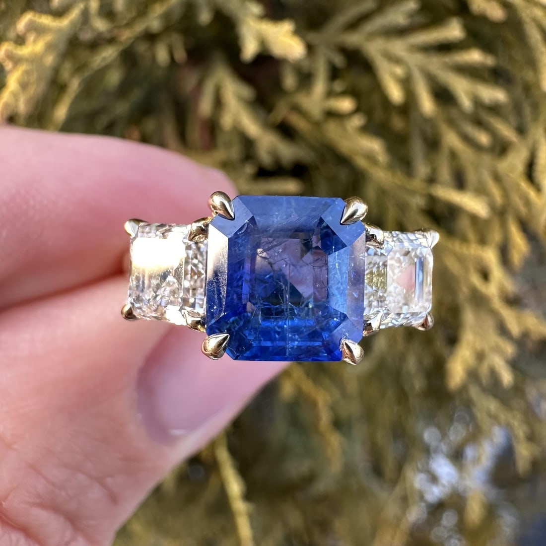 18k Yellow Gold Three Stone Burma Sapphire and Diamond Ring GIA Certified: 18k Yellow Gold Three Stone Burma Sapphire and Diamond Ring GIA Certified This un-used 18k yellow gold cocktail ring features a rare, vintage Burma sapphire at its center, weighing 3.28 carats, with a