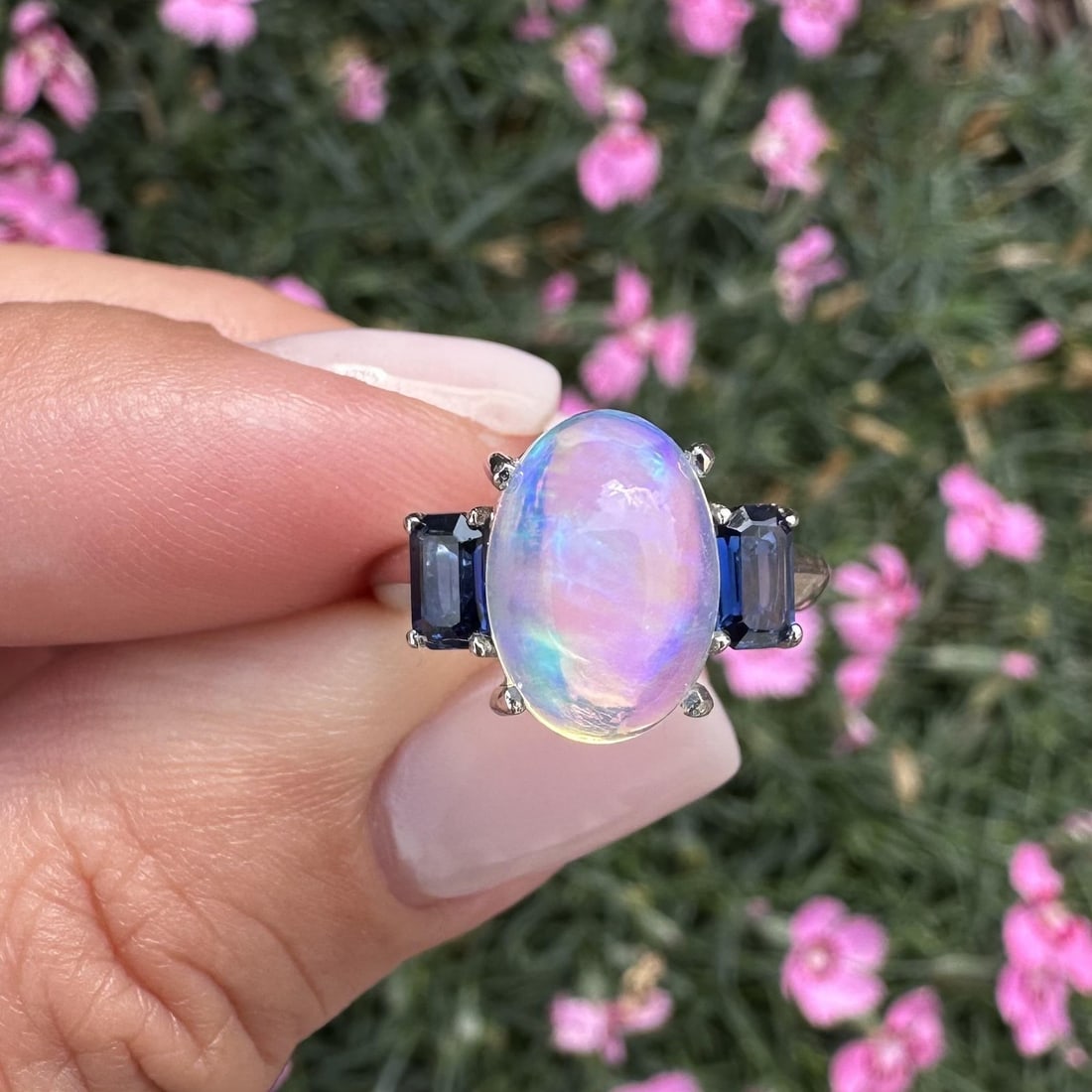 Platinum 3.89ct Oval Jelly Opal & Blue Sapphire Cocktail Ring: Platinum 3.89ct Oval Jelly Opal & Blue Sapphire Cocktail Ring This exquisite cocktail ring showcases a stunning natural jelly opal in an oval cabochon cut, expertly prong set to highlight its captivat