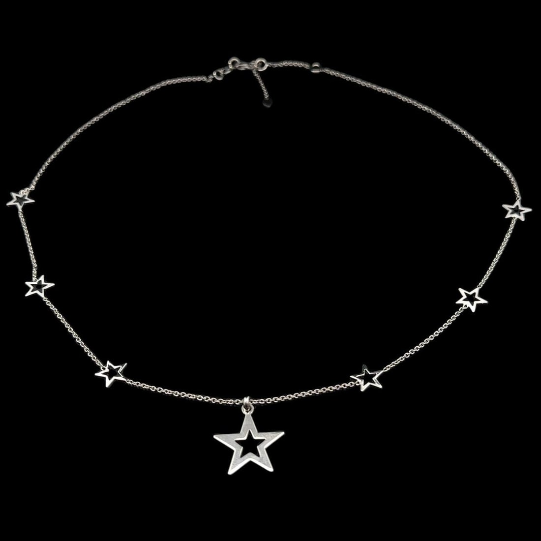 Art by Celin 14k White Gold Star Pendant Adjustable Necklace: Art by Celin 14k White Gold Star Pendant Adjustable Necklace This elegant pendant necklace features a stunning cut-out star design crafted from solid 14k white gold. The necklace showcases a fine cabl